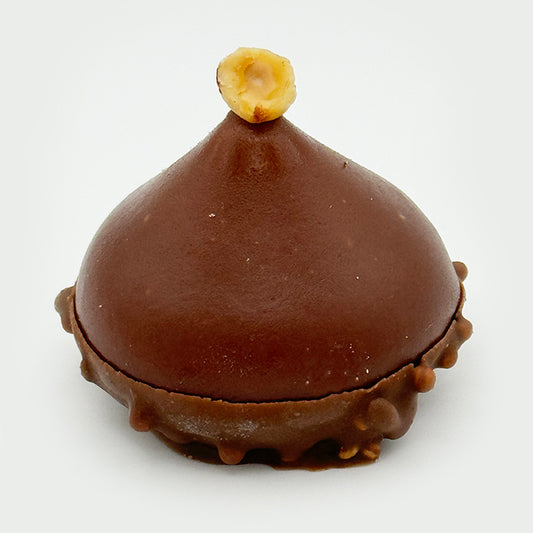 "Refined dessert featuring silky chocolate and hazelnut mousse, layered with buttery croissant crème, soft chocolate sponge, and crisp quinoa crunch.