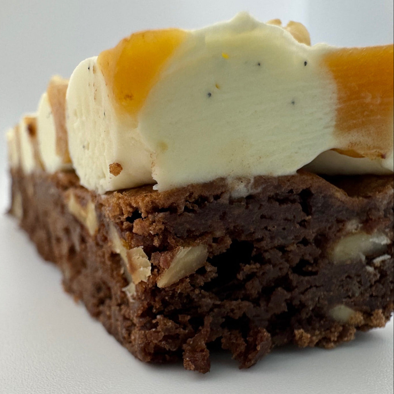 Fudgy hazelnut brownie topped with a swirl of salted caramel and light whipped white chocolate vanilla ganache, finished with roasted hazelnut pieces.