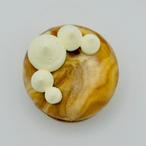 "Decadent dessert combining rich sticky toffee pudding and smooth Irish cream mousse, elegantly glazed in a marble chocolate finish and placed on a delicate sable base."