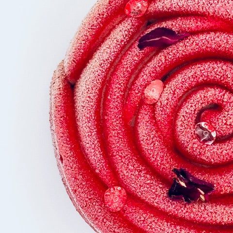 "Individual dessert in the shape of a rose, featuring raspberry mousse, pistachio sponge, and a crisp ruby chocolate crunch layer."