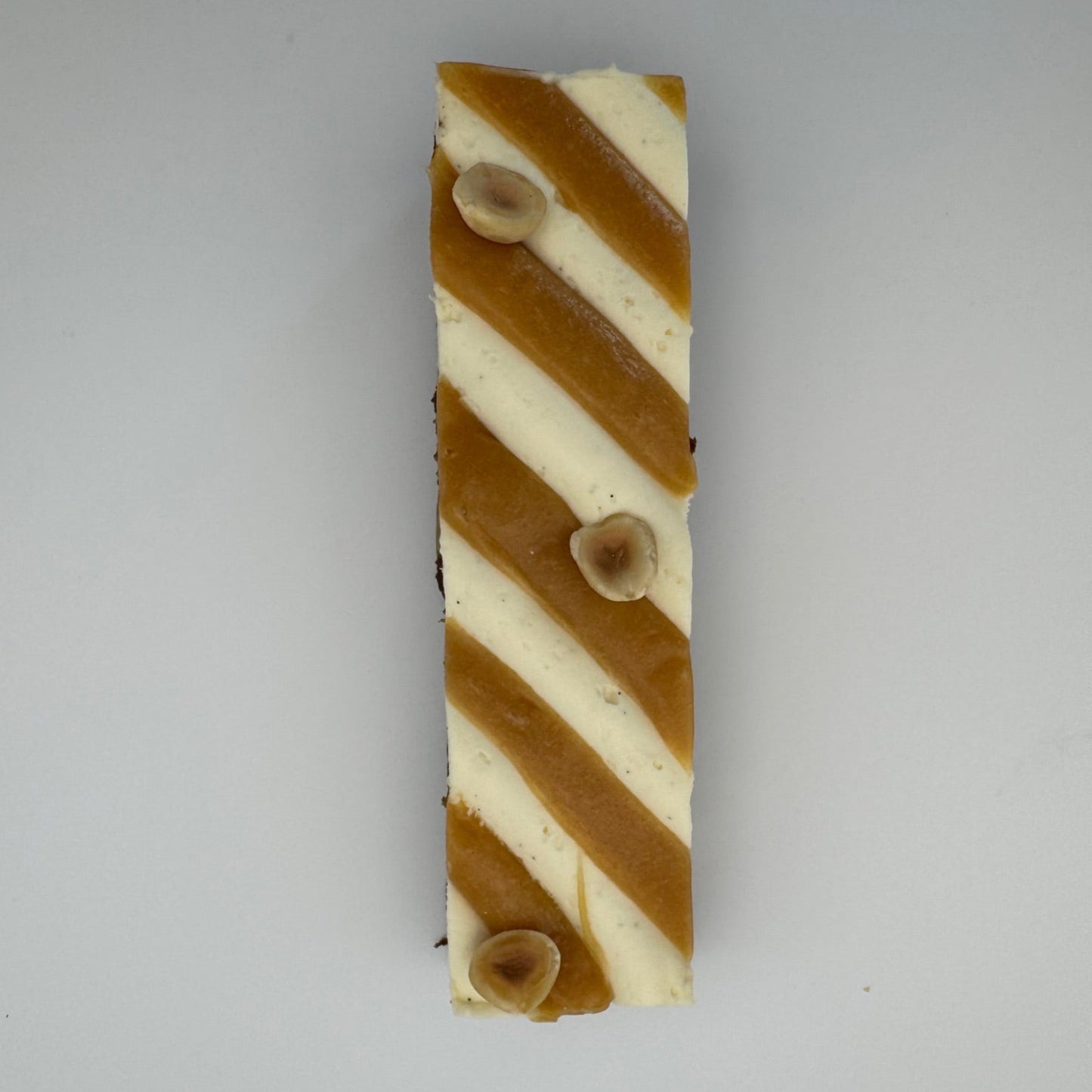 "Decadent chocolate brownie loaded with hazelnuts, layered with rich salted caramel and finished with airy white chocolate vanilla ganache."